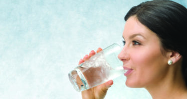 lady drinking from a glass of water