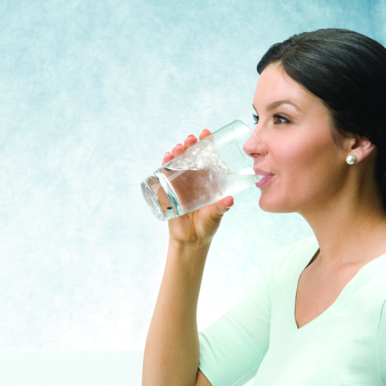 lady drinking from a glass of water