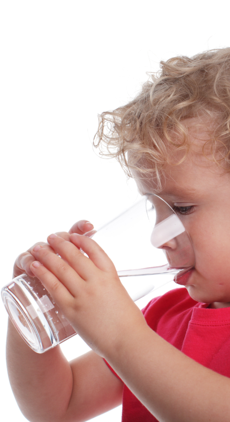 child drinking from a glass of water