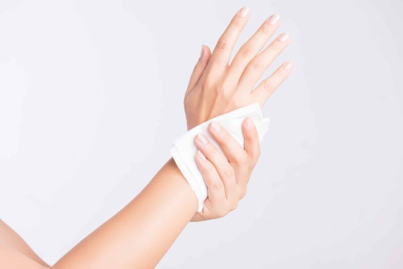 a person using a wet wipe to clean their hands