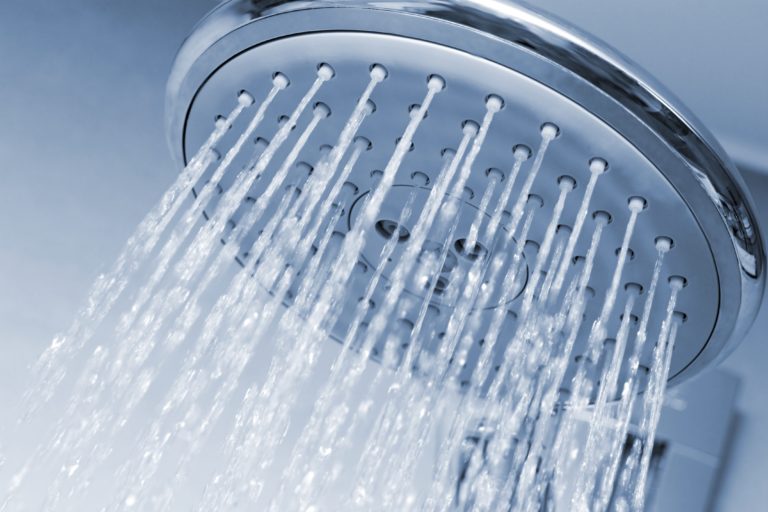 shower head that is spraying a constant stream of clear water