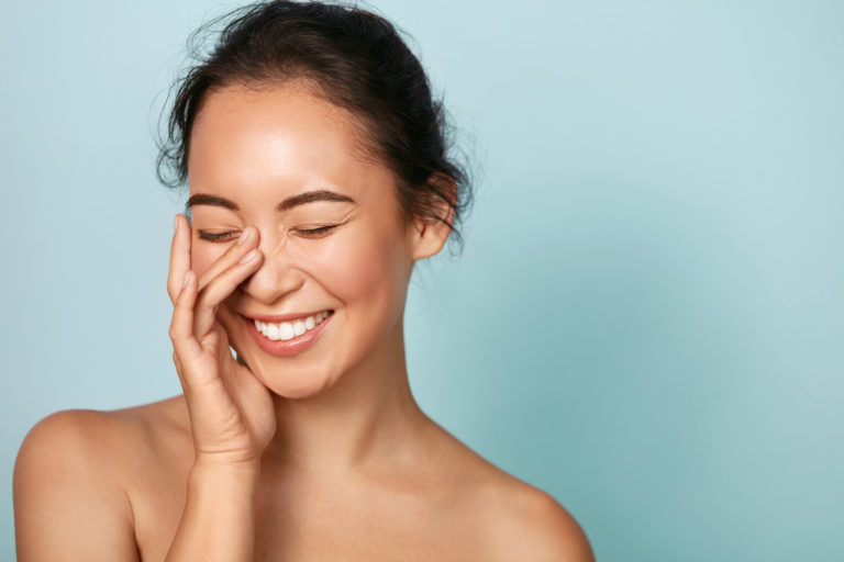 woman showing off her healthy skin due to her kinetico water softener