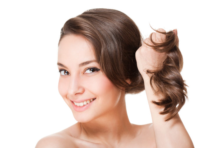 woman holding her healthy hair in her hand