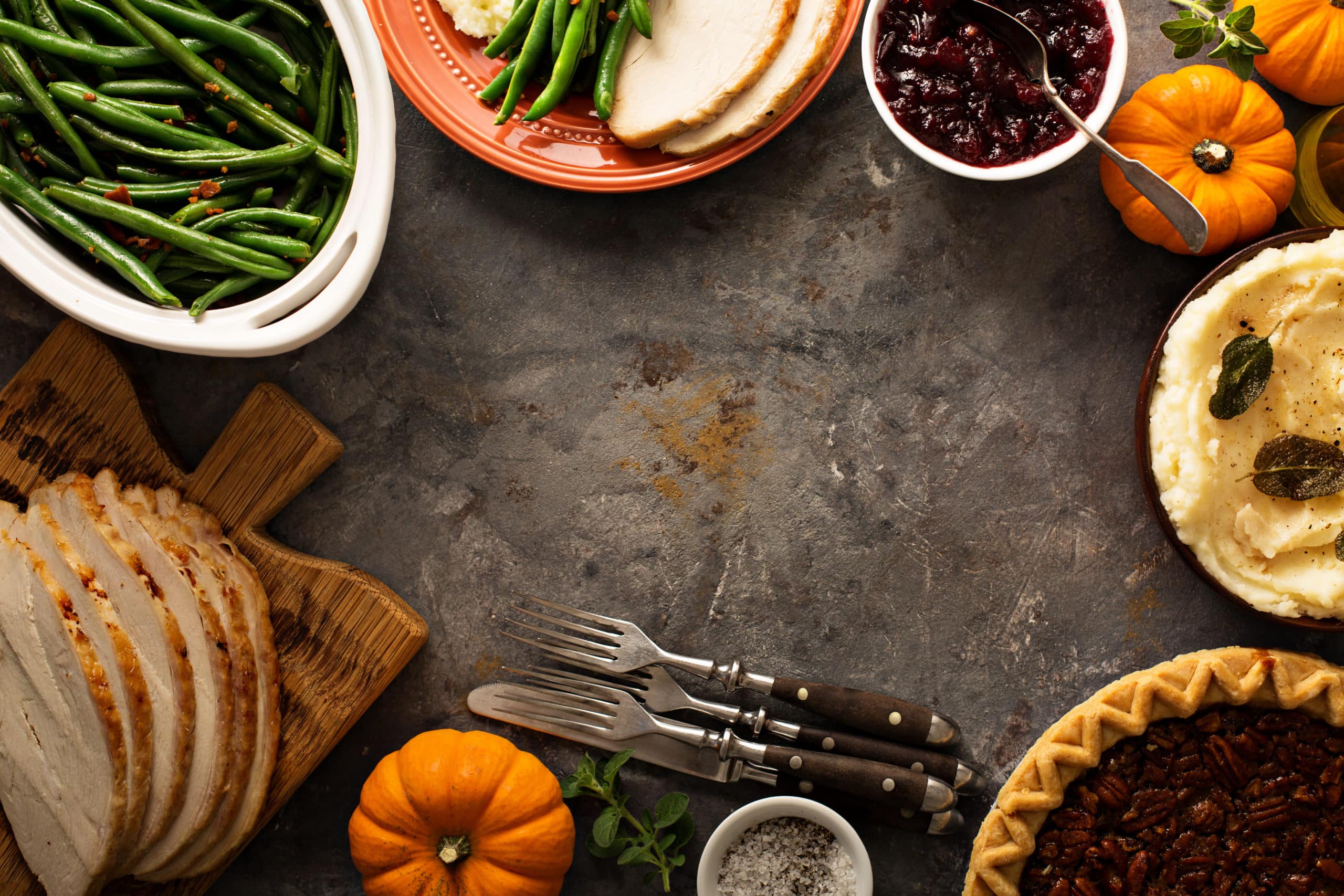 Thanksgiving table with turkey, green beans and mashed potatoes overhead shot