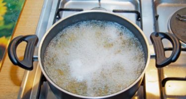 boiling noodles in a cooking pot
