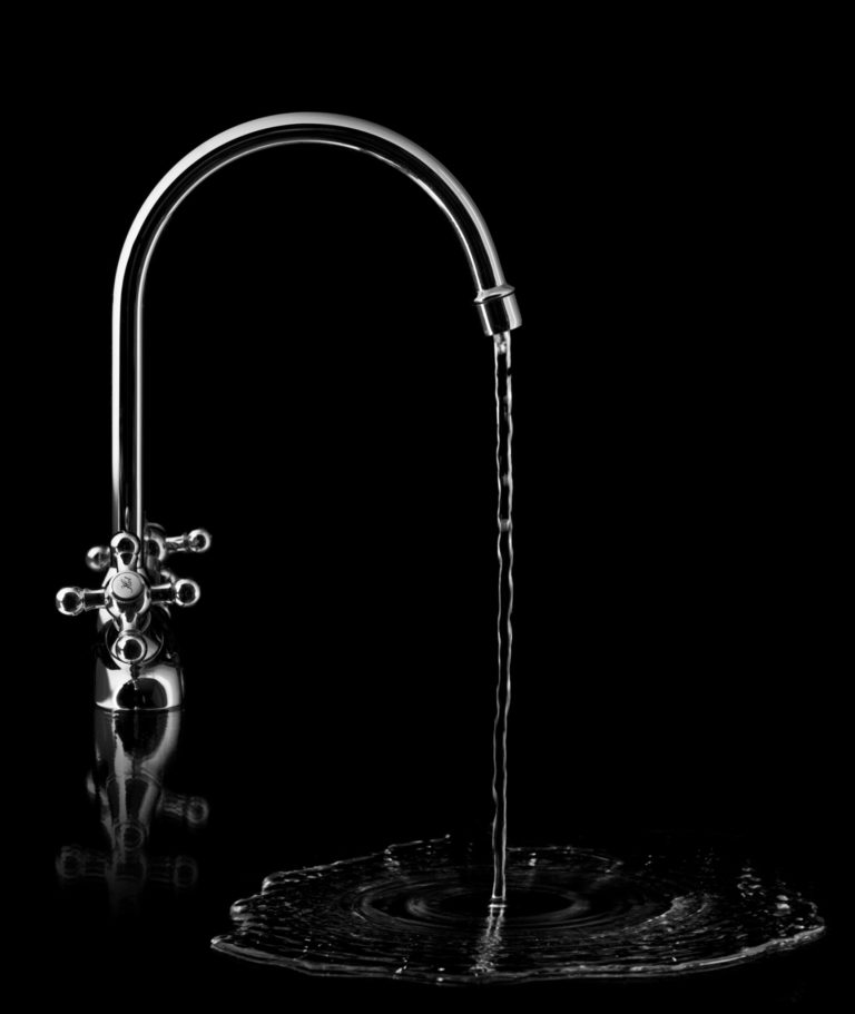 kinetico faucet on a black back drop