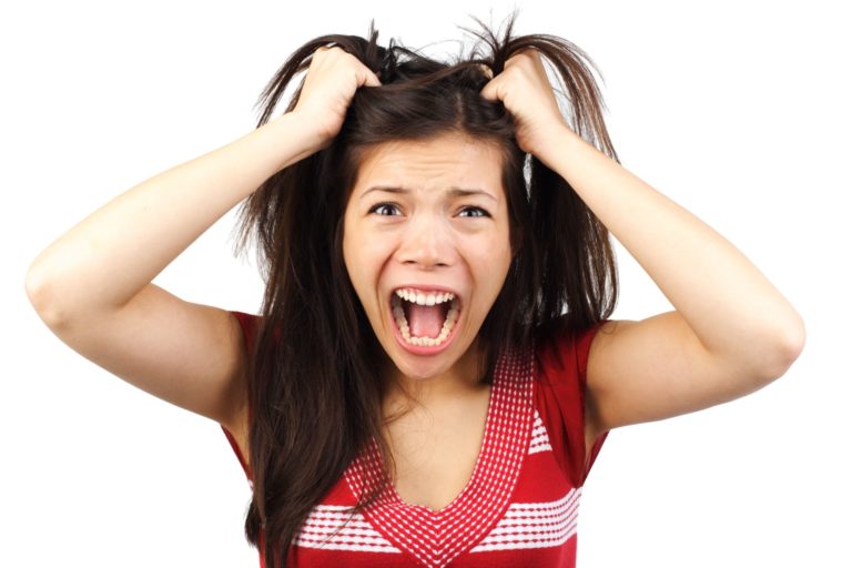 woman pulling her hair out from stress due to the holidays