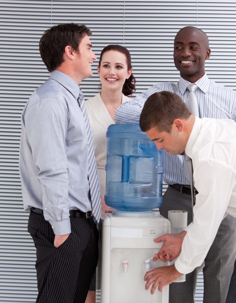 office staff gathering around a water cooler in the office