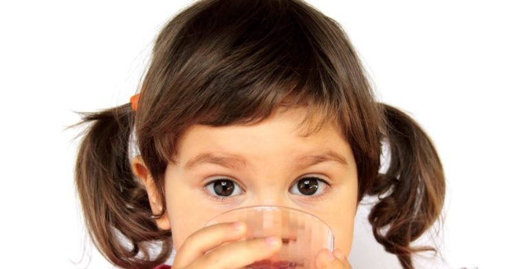 child drinking water from a glass