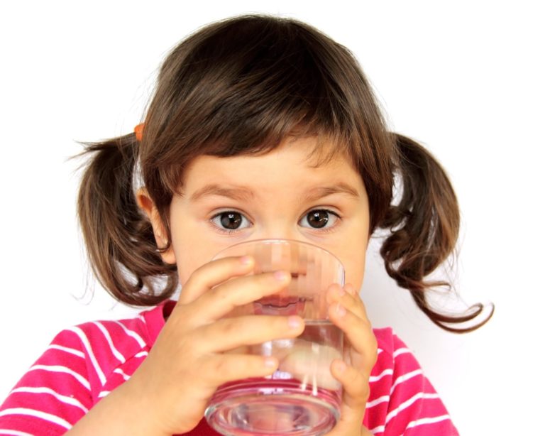 child drinking water from a glass