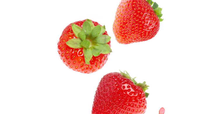 strawberries and strawberry juice on a white background