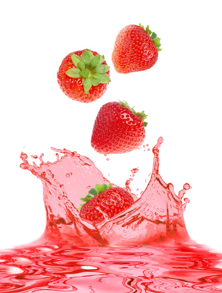 strawberries and strawberry juice on a white background