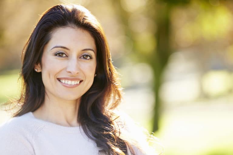 woman posing on a coutry side hill