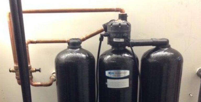black kinetico water softeners that have been installed in a san antonio home