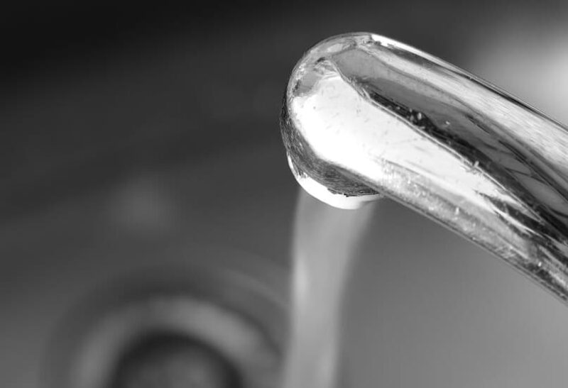 hard water coming out of a kitchen sink faucet