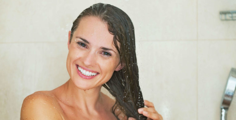 woman cleaning her hair in the shower with soft water