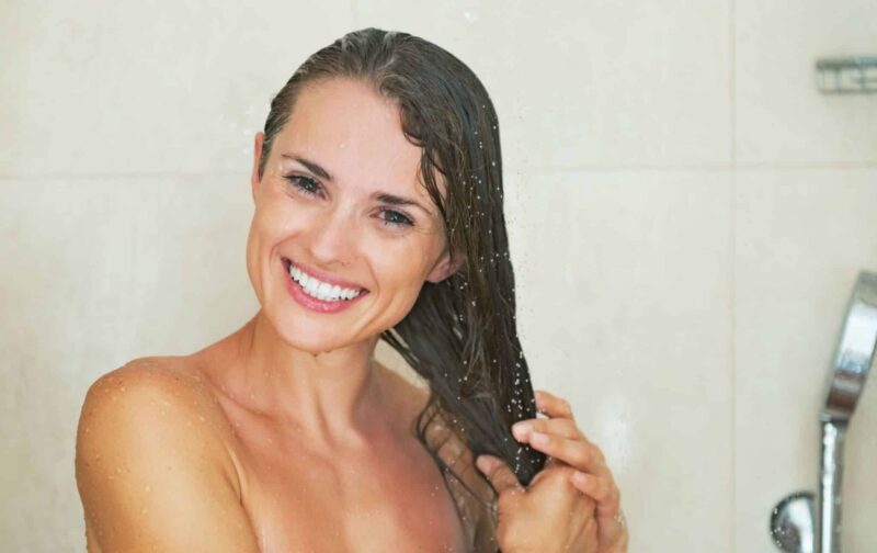 woman cleaning her hair in the shower with soft water