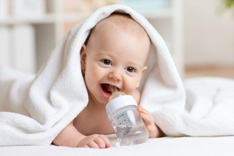 baby teething a bottle filled with water