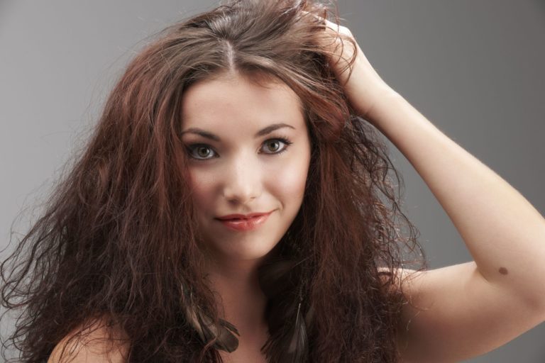 woman with frizzy hair due to hard water build up