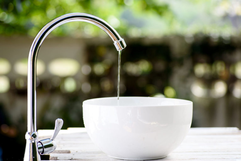 leaking faucet that being poured into a bowl