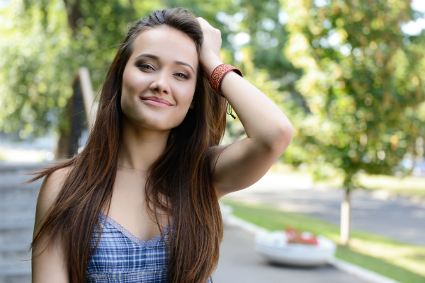 lady showing her clear skin and silky hair after using a kinetico water softener