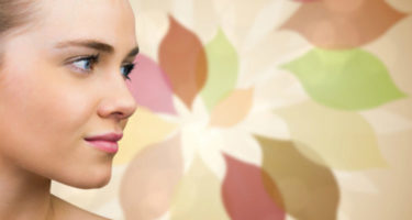 woman looking away with a colorful design in the background