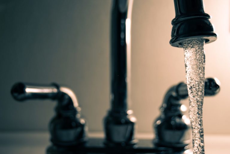 water flowing from a kitchen sink faucet