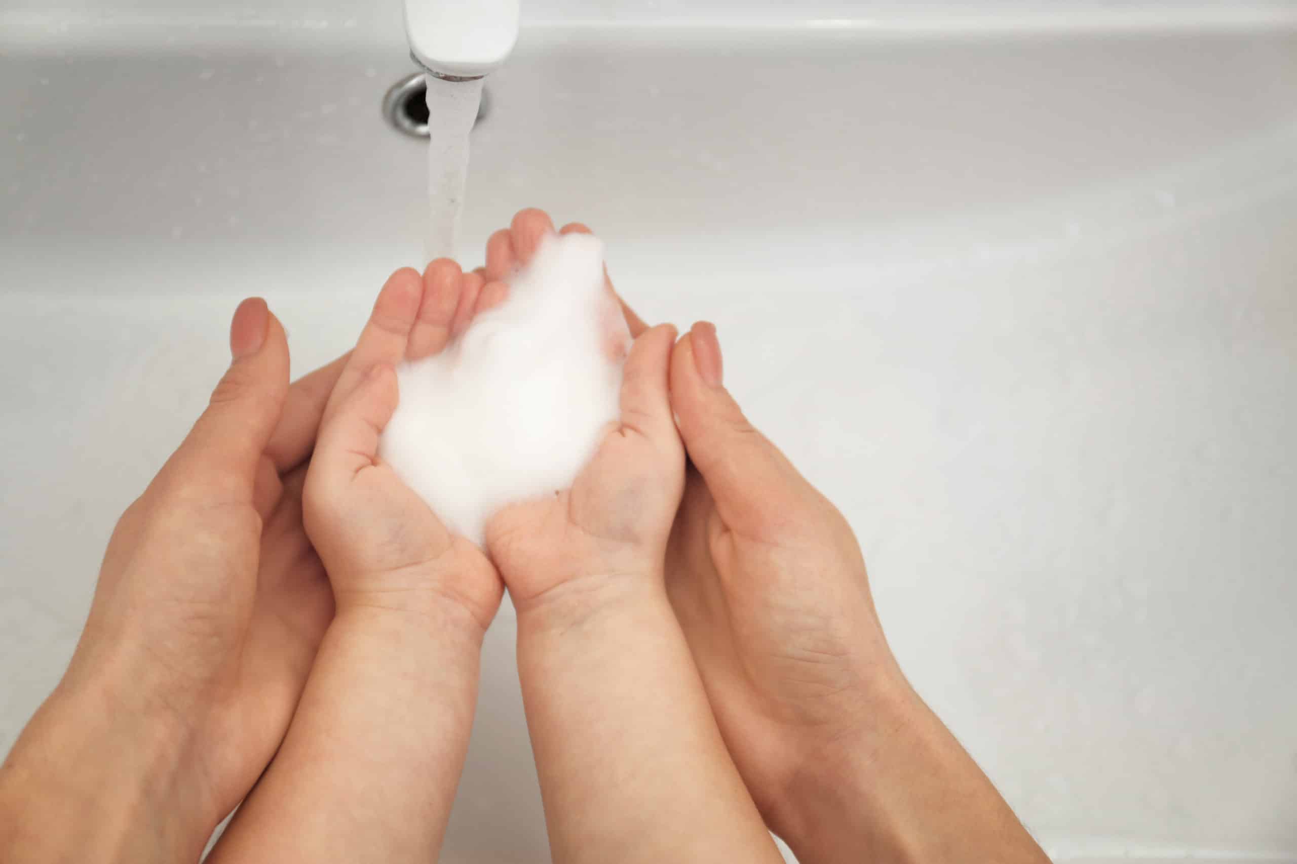 mother and daughter washing their hands together