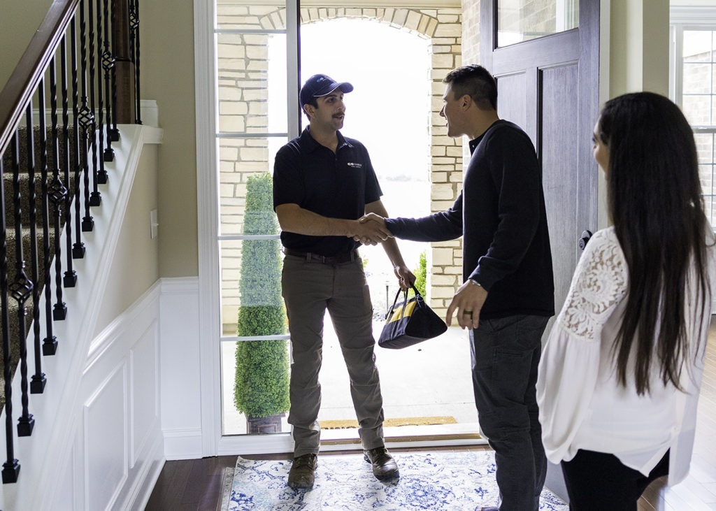 kinetico tech greeting his customers as he enters their home