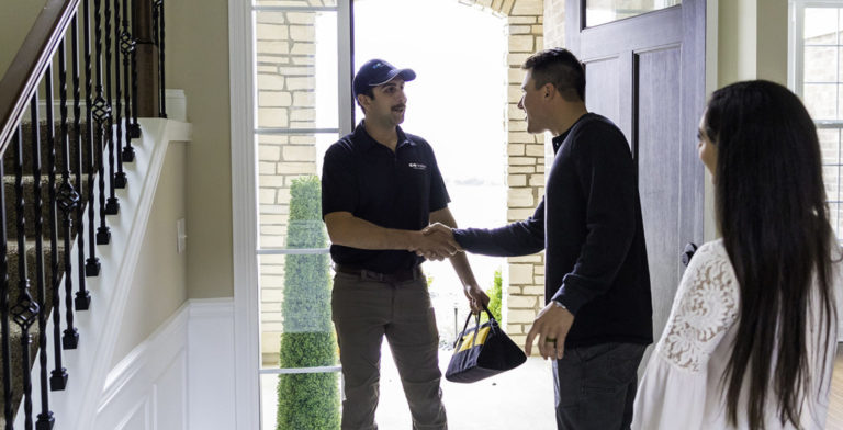 kinetico tech greeting his customers as he enters their home