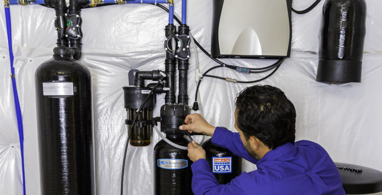 technician installing a water softener in San Antonio