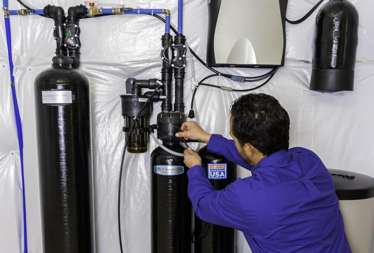 technician installing a water softener in San Antonio