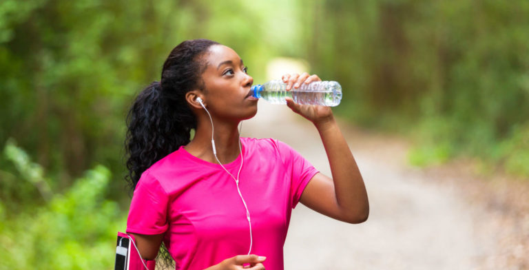 woman drinking water on the trail