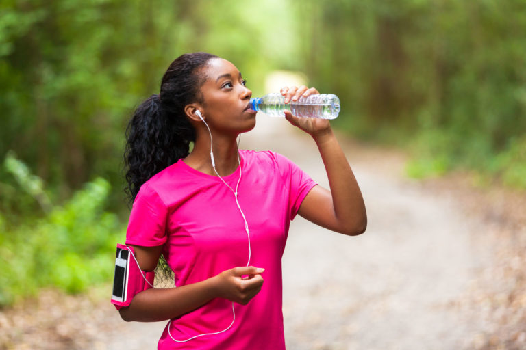 woman drinking water on the trail