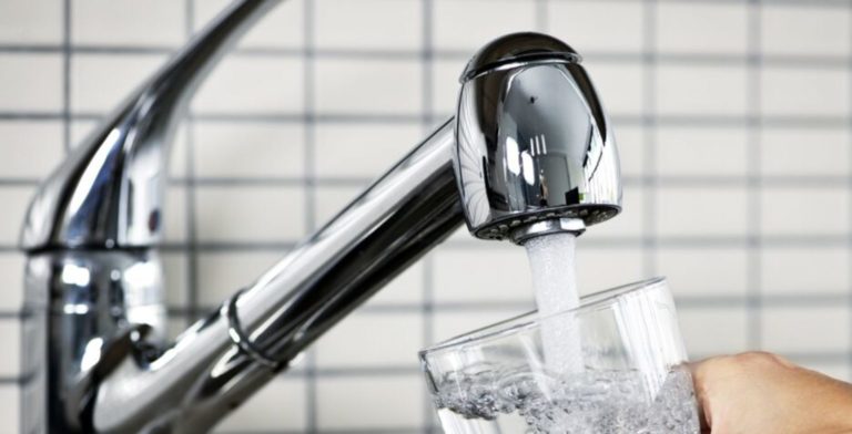 faucet filling up a glass of water