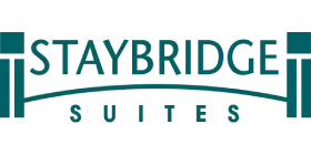 Logo for Staybridge Suites featuring the hotel name in teal capital letters with a stylized bridge arch beneath the word STAYBRIDGE and the word SUITES below the arch.