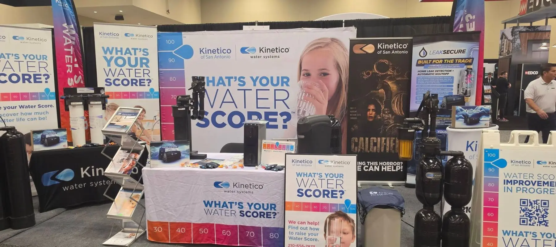Kinetico water systems trade show booth featuring banners and signs about Whats Your Water Score? along with displays of water filtration equipment.